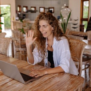 woman-in-white-shirt-sitting-on-chair-in-front-of-macbook-4458421